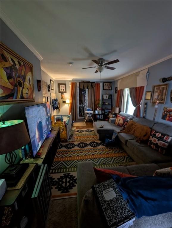 living room featuring ornamental molding, carpet, and ceiling fan