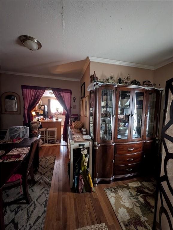 dining area featuring hardwood / wood-style floors and crown molding