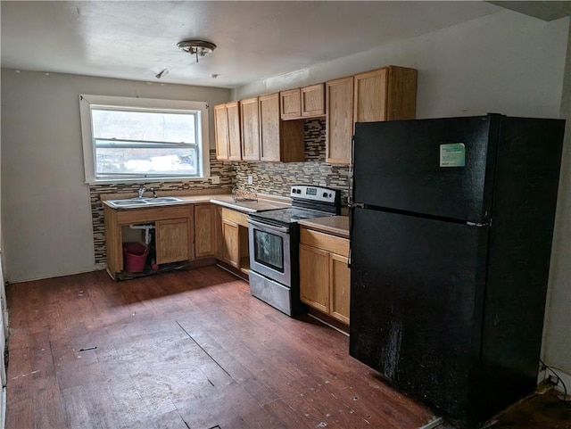 kitchen with freestanding refrigerator, dark wood-style flooring, backsplash, and stainless steel electric range