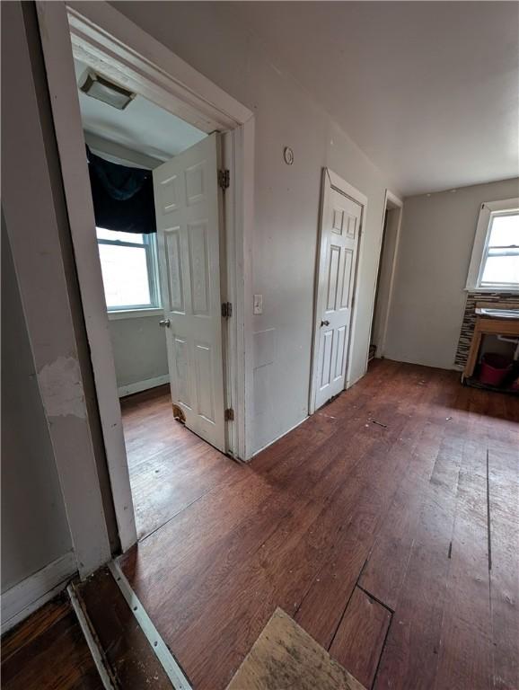 hallway with wood-type flooring and visible vents