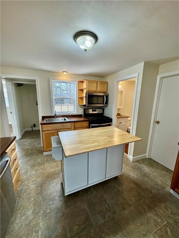 4027 Rockwell Ave, Horseheads, NY 14845 - kitchen featuring a center island, open shelves, stainless steel appliances, wooden counters, and a sink