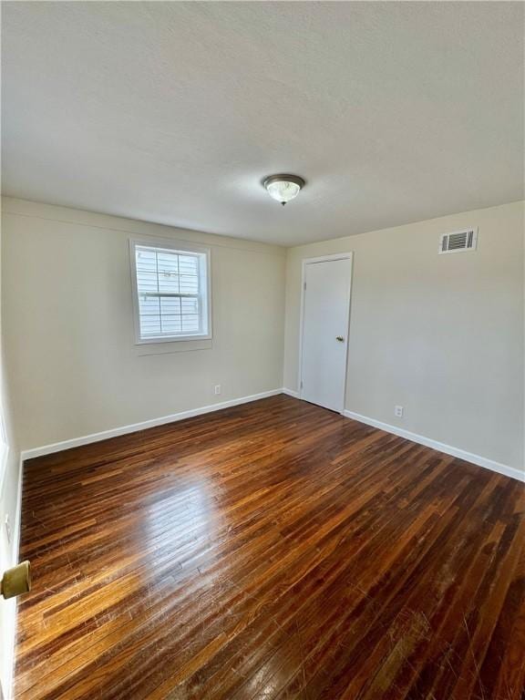 4027 Rockwell Ave, Horseheads, NY 14845 - empty room featuring dark wood-style flooring, visible vents, and baseboards