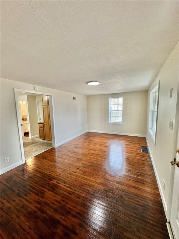 4027 Rockwell Ave, Horseheads, NY 14845 - spare room featuring baseboards, a textured ceiling, visible vents, and hardwood / wood-style floors