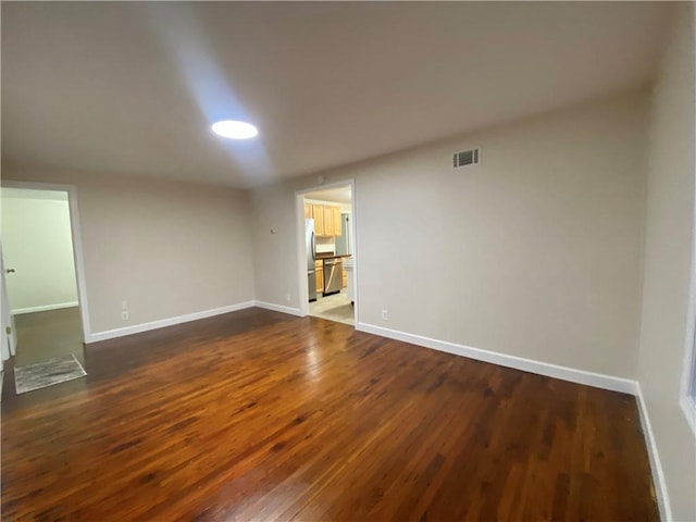 4027 Rockwell Ave, Horseheads, NY 14845 - empty room with dark wood-style floors, visible vents, and baseboards
