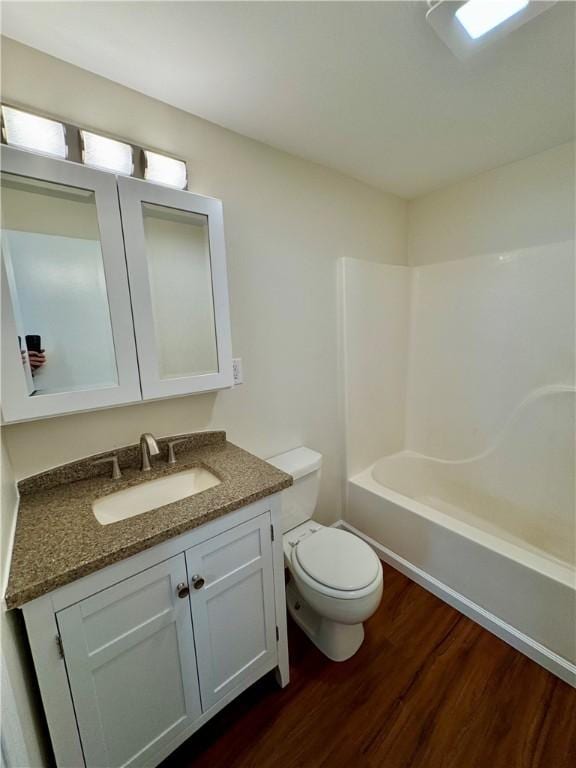 4027 Rockwell Ave, Horseheads, NY 14845 - bathroom with vanity, bathing tub / shower combination, wood finished floors, and toilet