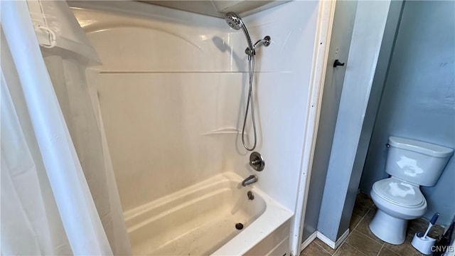 full bath featuring shower / bath combo, toilet, and tile patterned floors