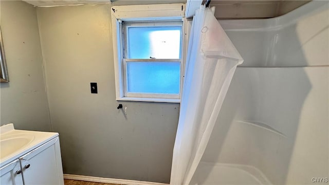 bathroom featuring curtained shower and vanity