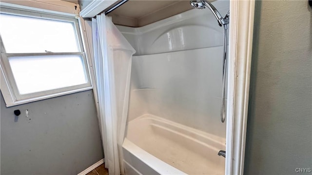 full bathroom with a shower, a textured wall, and a bathing tub