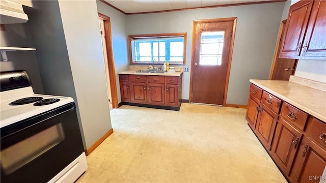 kitchen with electric range, light floors, light countertops, under cabinet range hood, and a sink