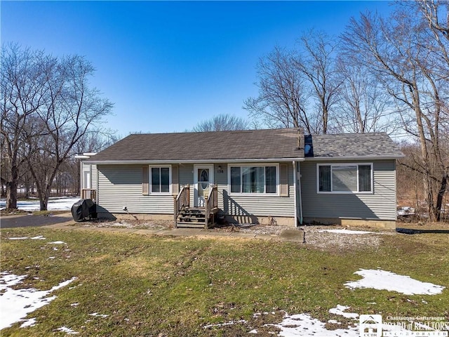 view of front of home with a shingled roof and a front yard