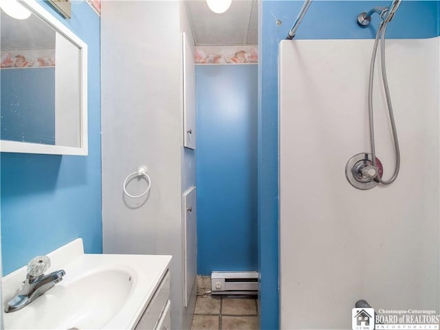 full bathroom with tile patterned floors, walk in shower, vanity, and a baseboard radiator