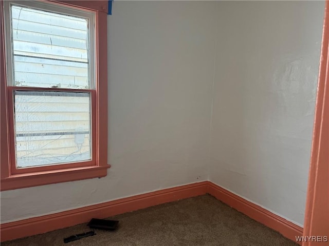 carpeted empty room with visible vents and baseboards