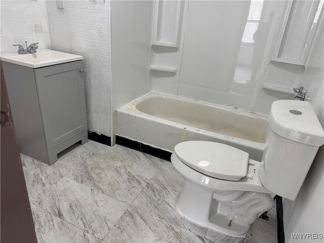 full bath with bathing tub / shower combination, vanity, toilet, and tile walls