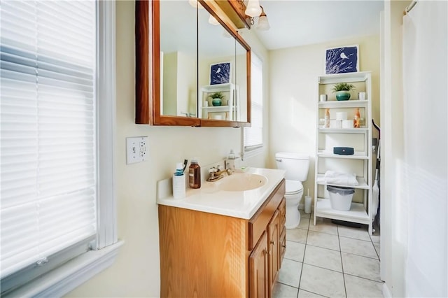 bathroom featuring vanity, toilet, and tile patterned floors