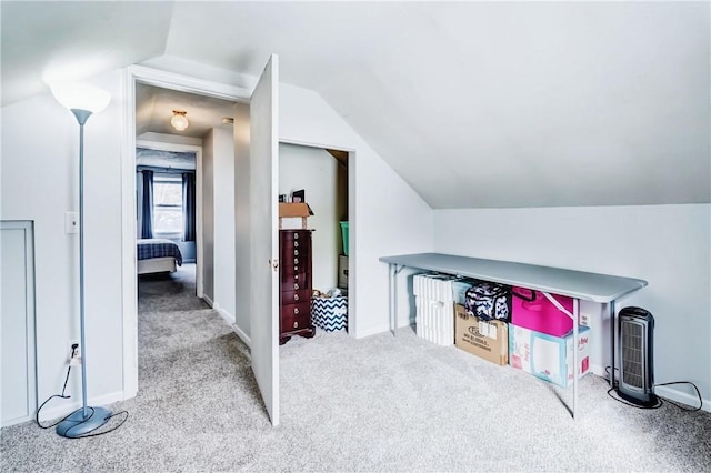 interior space with lofted ceiling, carpet flooring, and baseboards