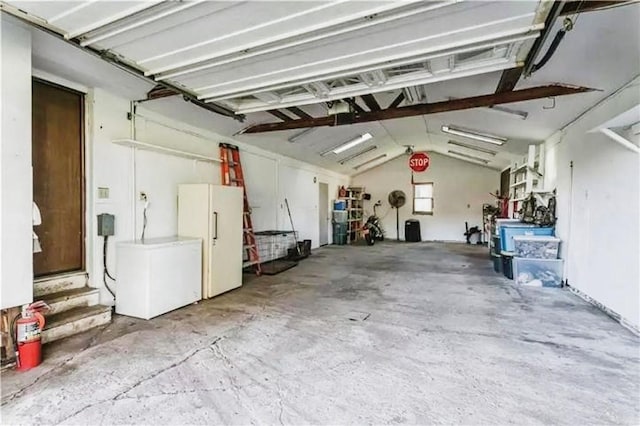 garage with freestanding refrigerator