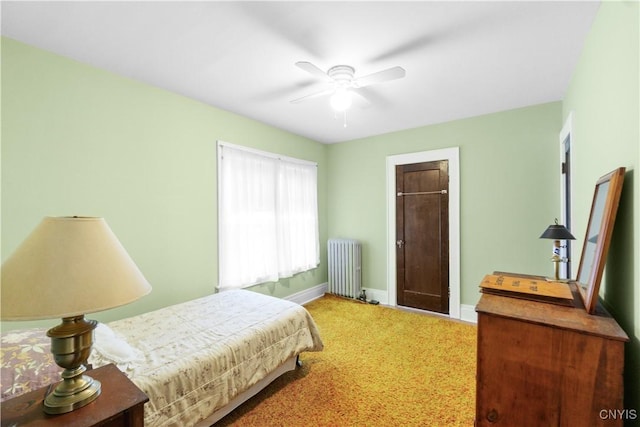 bedroom featuring radiator, ceiling fan, baseboards, and carpet flooring