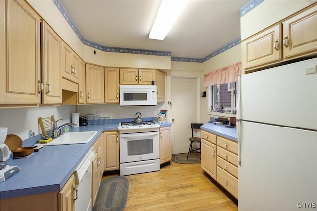 kitchen with white appliances, light brown cabinets, and light wood-style floors