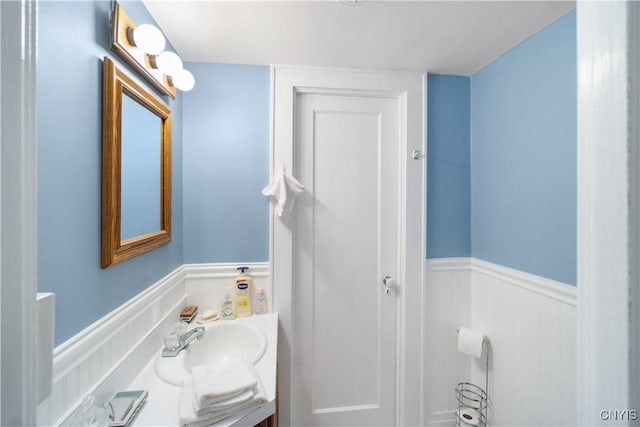 bathroom with wainscoting and vanity