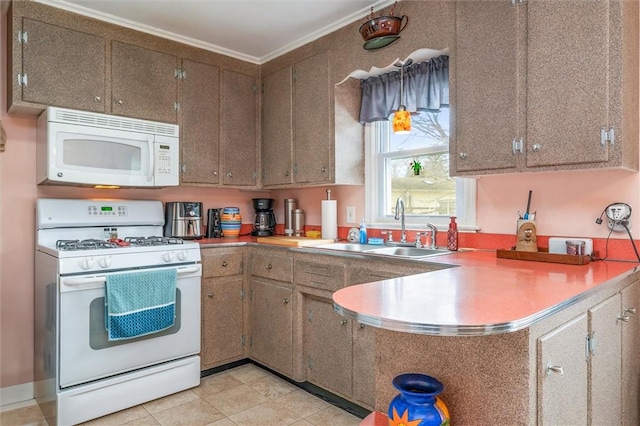 kitchen featuring white appliances, crown molding, light countertops, and a sink