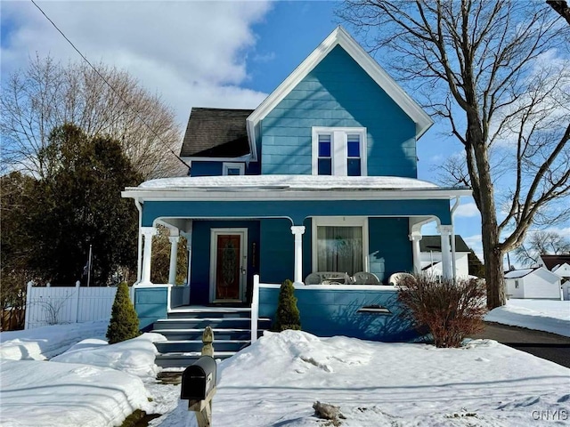 view of front of home featuring fence and a porch