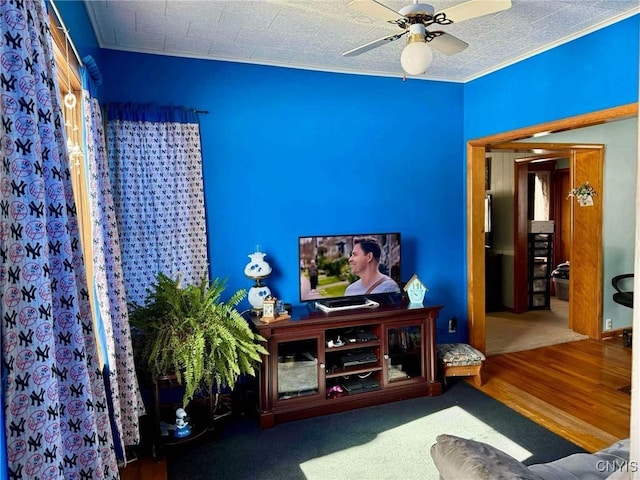 living area with ceiling fan and wood finished floors