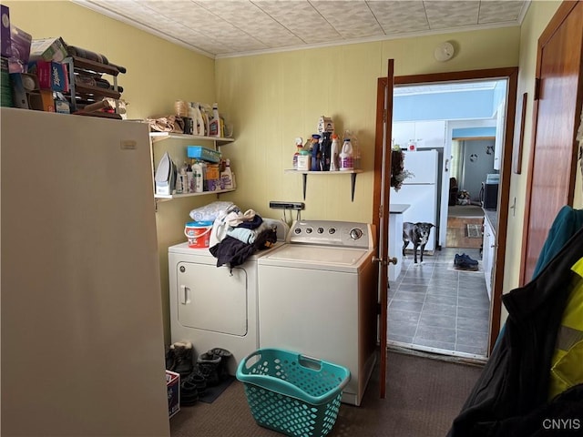 laundry room featuring washing machine and dryer, laundry area, and crown molding