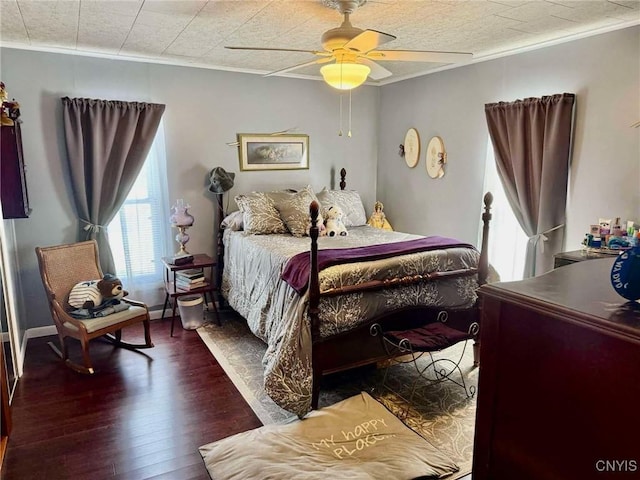 bedroom with ceiling fan, wood finished floors, and crown molding