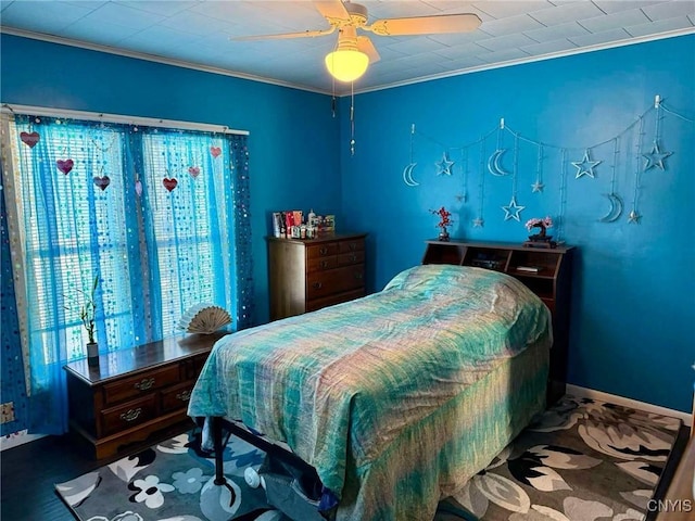 carpeted bedroom featuring baseboards, a ceiling fan, and crown molding