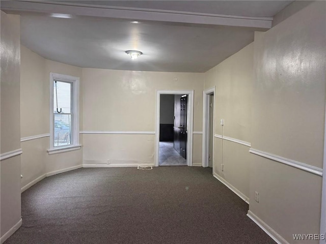 carpeted empty room featuring baseboards