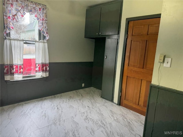 unfurnished room featuring marble finish floor and visible vents