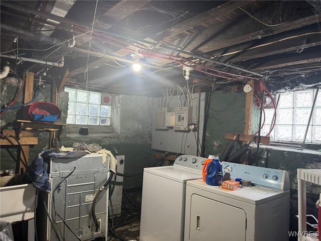 laundry room featuring laundry area, plenty of natural light, and separate washer and dryer