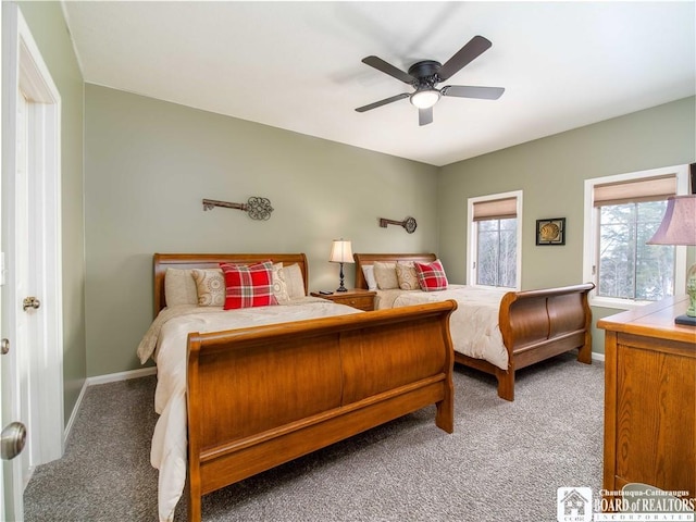 carpeted bedroom with baseboards and a ceiling fan