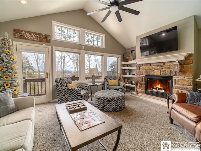 living room featuring high vaulted ceiling, a fireplace, carpet flooring, and a ceiling fan