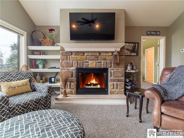 sitting room with a fireplace and carpet flooring