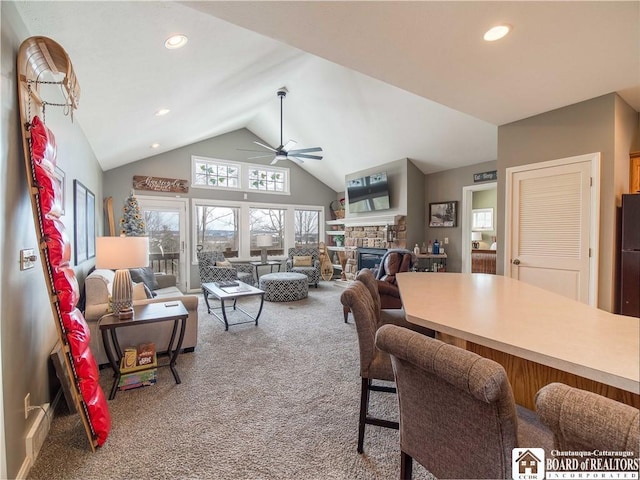 interior space with high vaulted ceiling, recessed lighting, a fireplace, a ceiling fan, and carpet