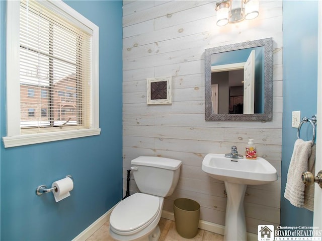 bathroom featuring toilet and baseboards