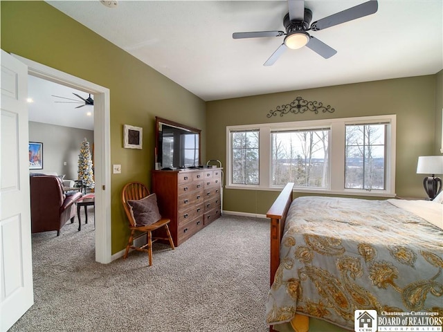 carpeted bedroom featuring ceiling fan, multiple windows, and baseboards