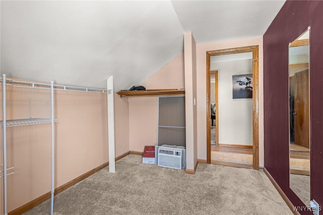 interior space with carpet floors and vaulted ceiling