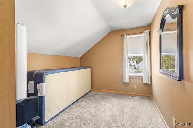 bonus room featuring vaulted ceiling, carpet floors, visible vents, and baseboards