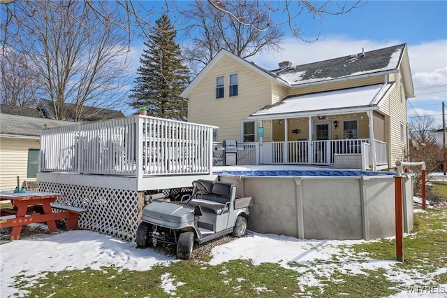 snow covered house featuring a deck