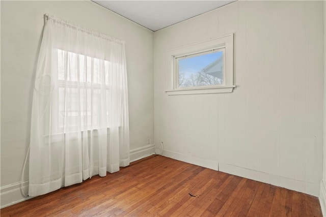 empty room with hardwood / wood-style floors