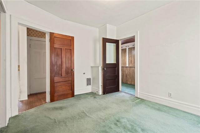 unfurnished bedroom with baseboards, visible vents, and carpet flooring