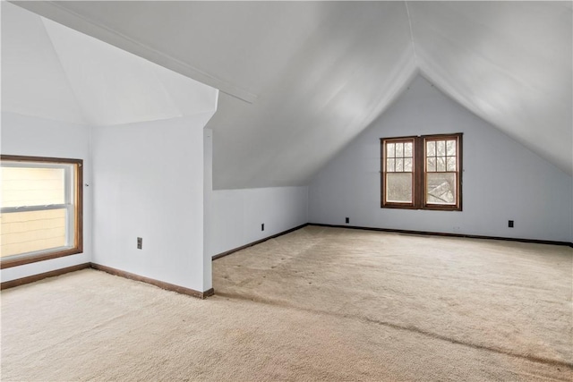 bonus room with vaulted ceiling, carpet, and baseboards