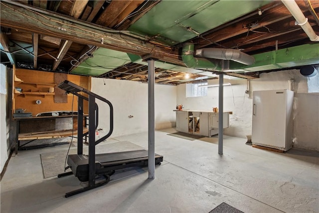 basement featuring freestanding refrigerator