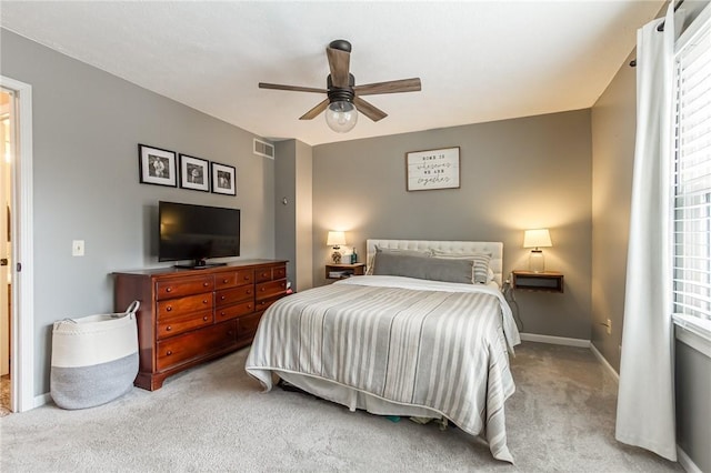 bedroom featuring ceiling fan, visible vents, baseboards, and carpet flooring