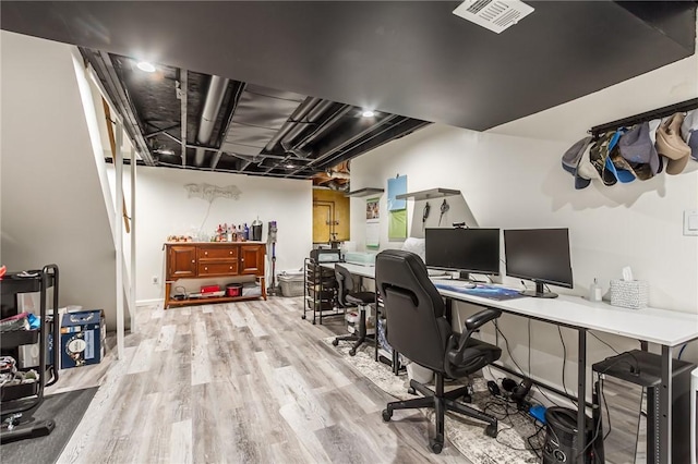 office area featuring light wood-type flooring and visible vents