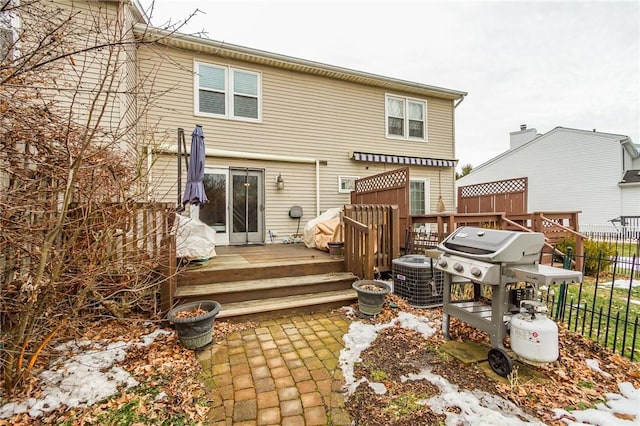 rear view of property with fence, central AC, and a wooden deck