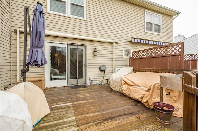 back of property featuring fence and a deck