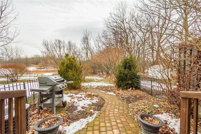 snowy yard with fence